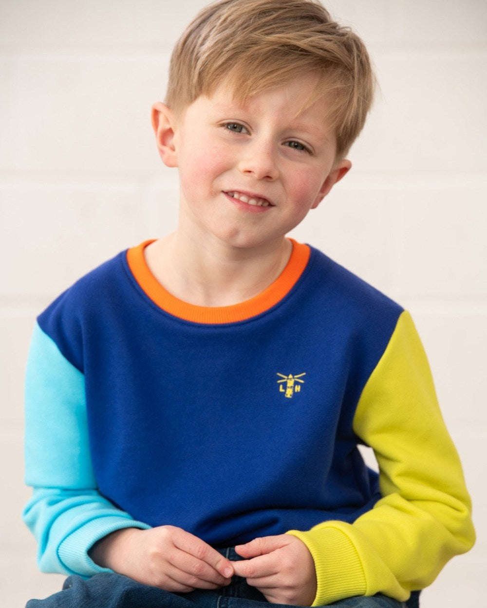 Blue Navy Lime coloured Lighthouse Childrens Finn Jersey on wall background