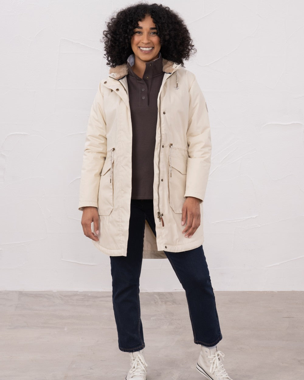 Irish Cream coloured Lighthouse Isobel Ladies Coat on wall background