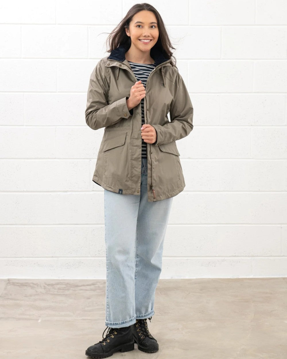 Fawn coloured Lighthouse Kendal Waterproof Coat on white wall background