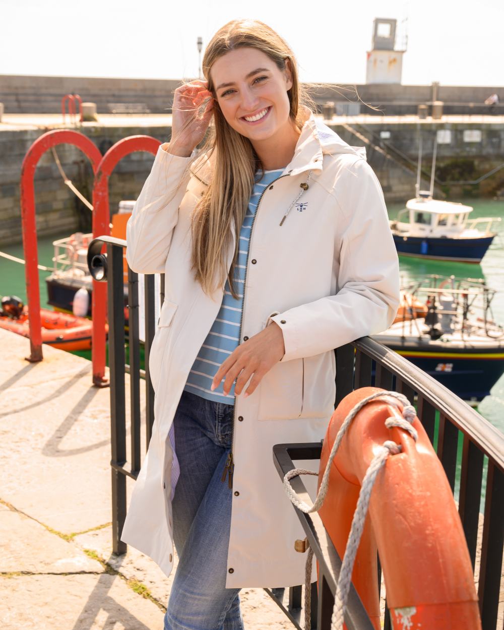 Cream coloured Lighthouse Ladies Annika Coat on port background