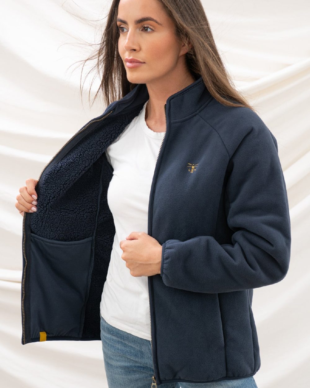 Navy coloured Lighthouse Ladies Avon Waterproof Fleece on curtain background