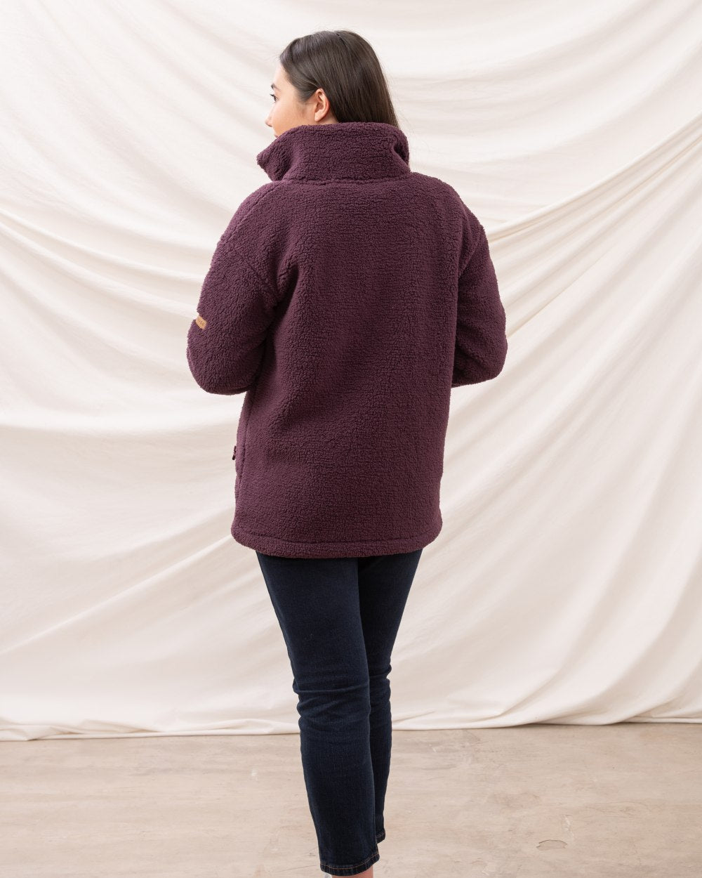 Cranberry coloured Lighthouse Ladies Cobh Full Zip Fleece Jacket on curtain background