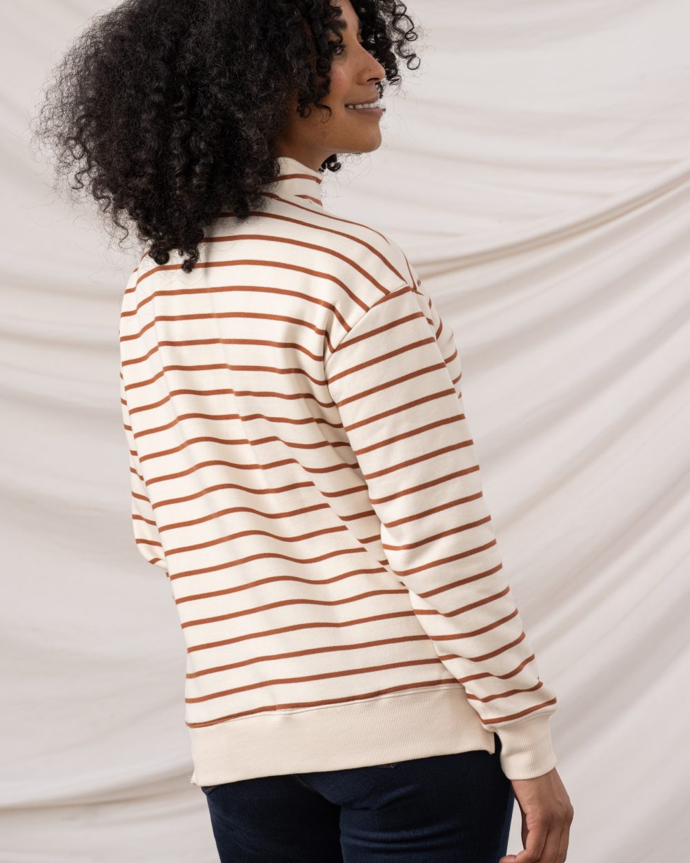 Rust Stripe coloured Lighthouse Ladies Coral Jersey on curtain background