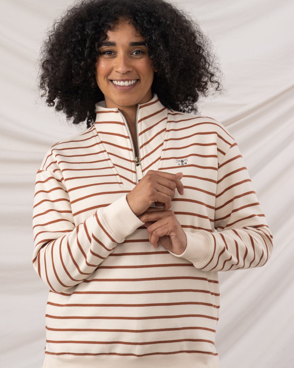 Rust Stripe coloured Lighthouse Ladies Coral Jersey on curtain background