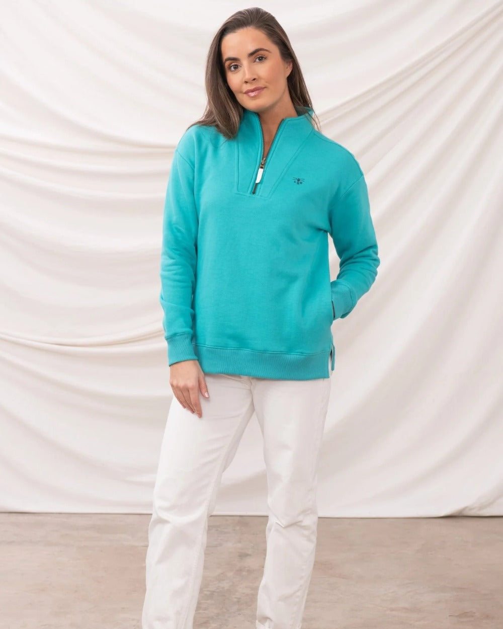 Soft Teal coloured Lighthouse Ladies Coral Jersey on curtain background