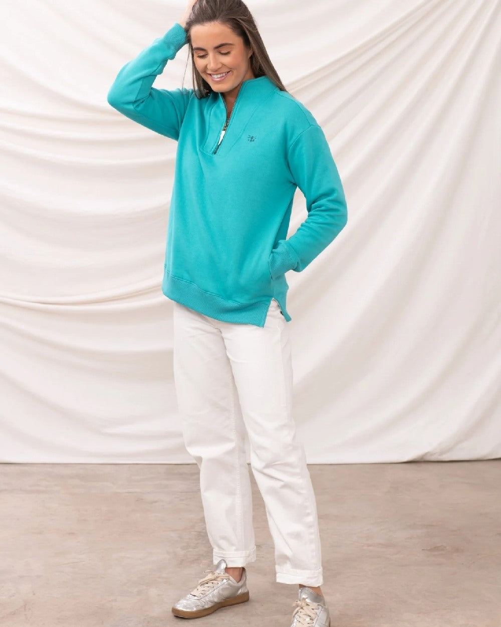 Soft Teal coloured Lighthouse Ladies Coral Jersey on curtain background