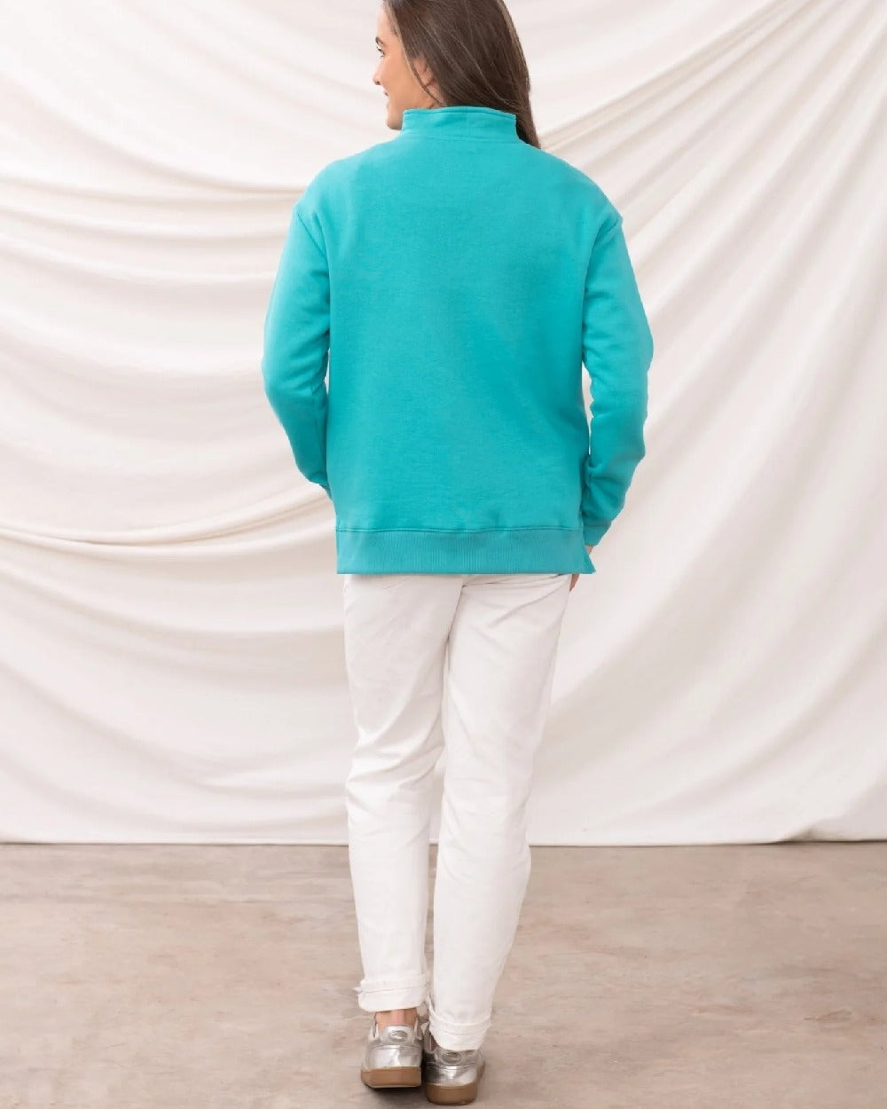 Soft Teal coloured Lighthouse Ladies Coral Jersey on curtain background