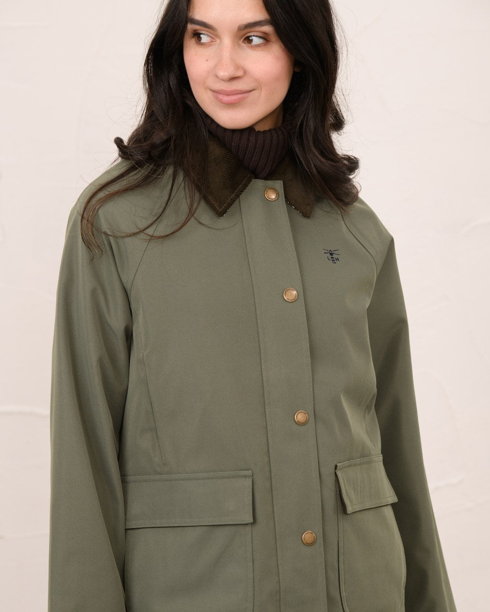 Olivine coloured Lighthouse Ladies Devon Raincoat on indoor background