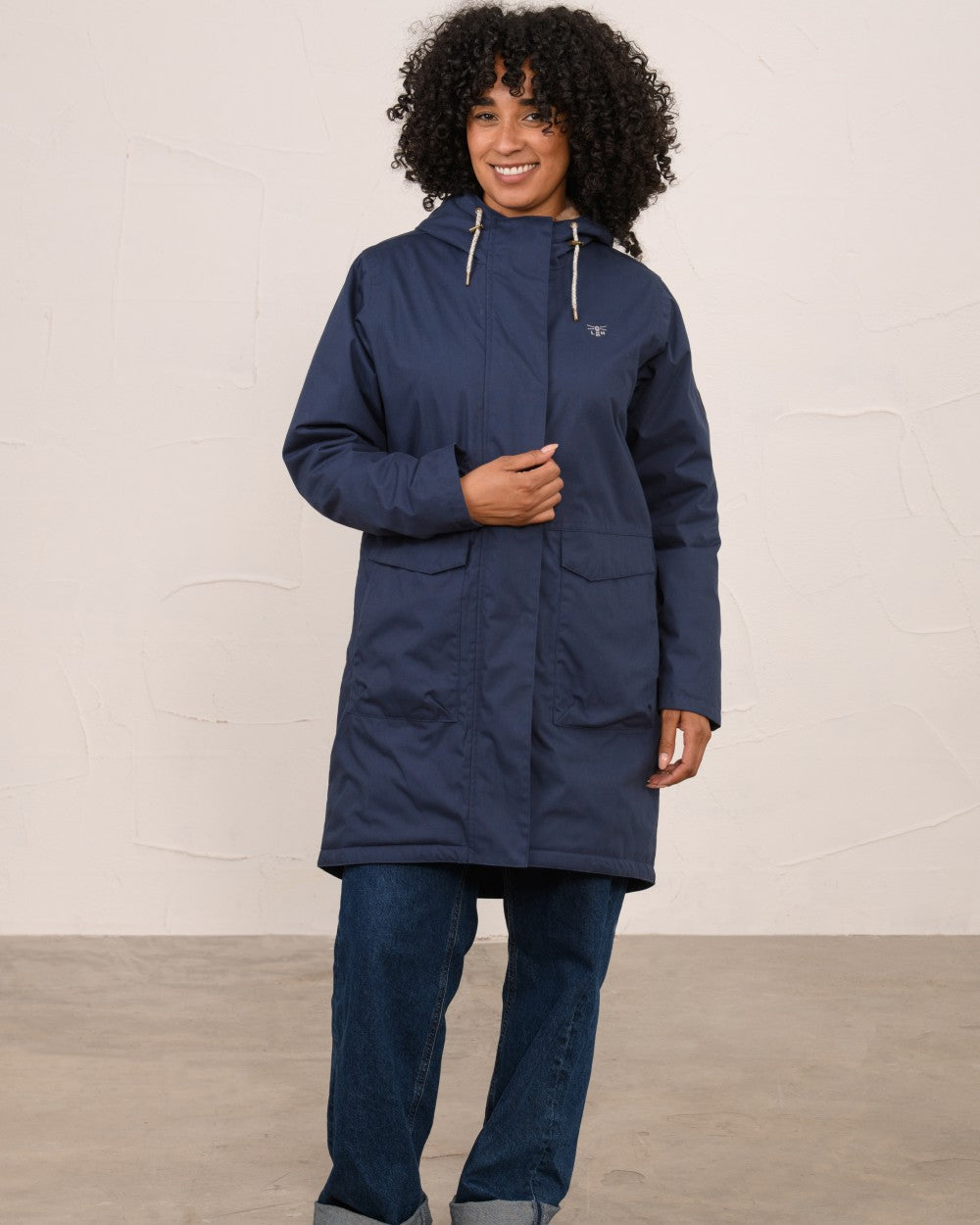 Navy coloured Lighthouse Ladies Fallon Coat on wall background