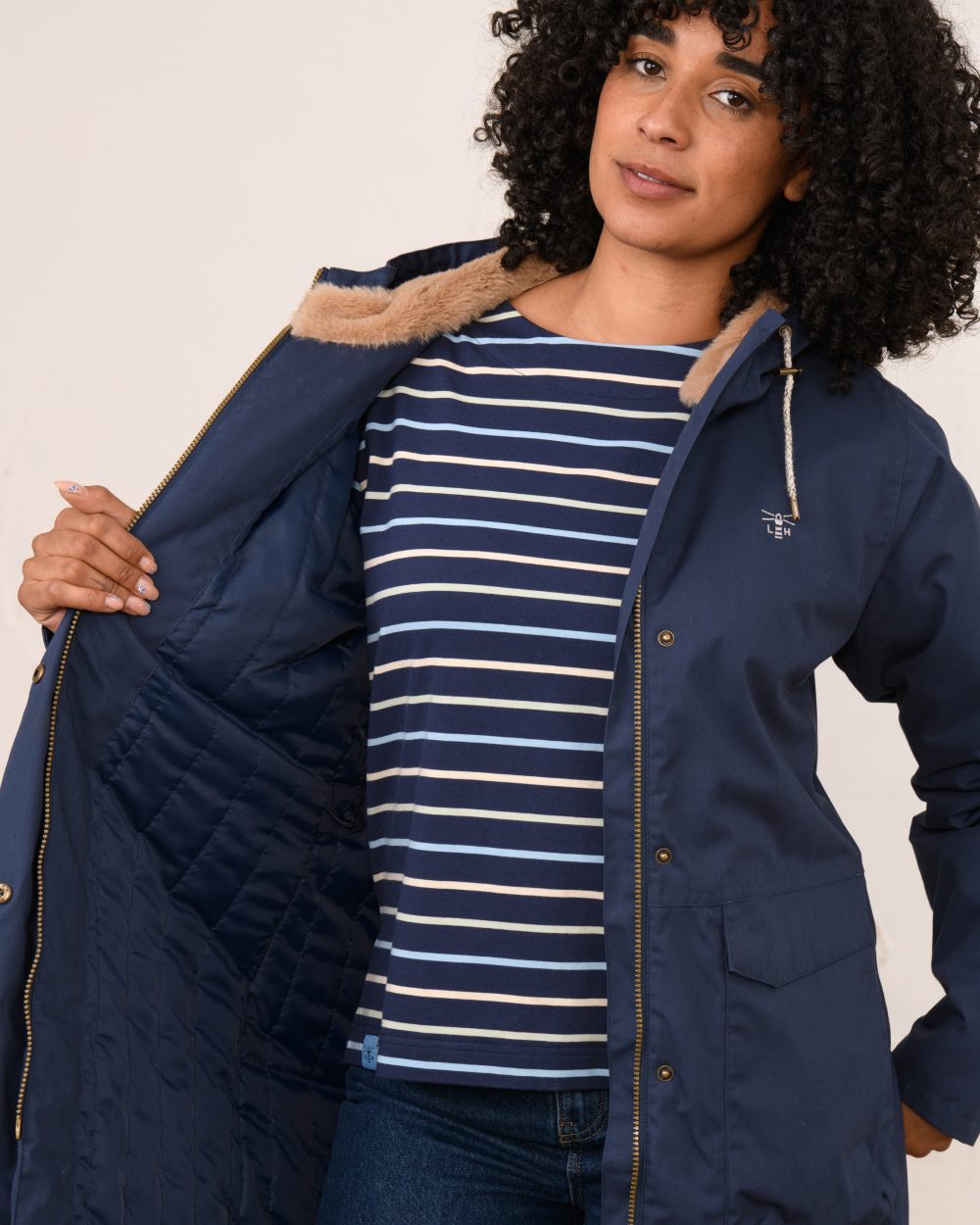 Navy coloured Lighthouse Ladies Fallon Coat on wall background
