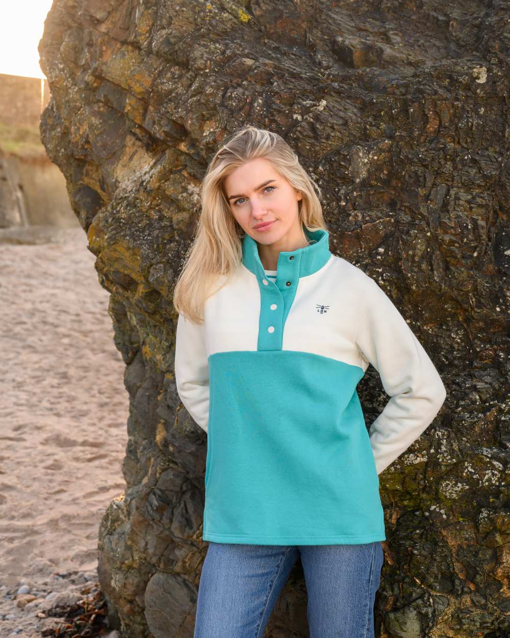 Coconut Soft Teal coloured Lighthouse Ladies Haven Jersey on rock background