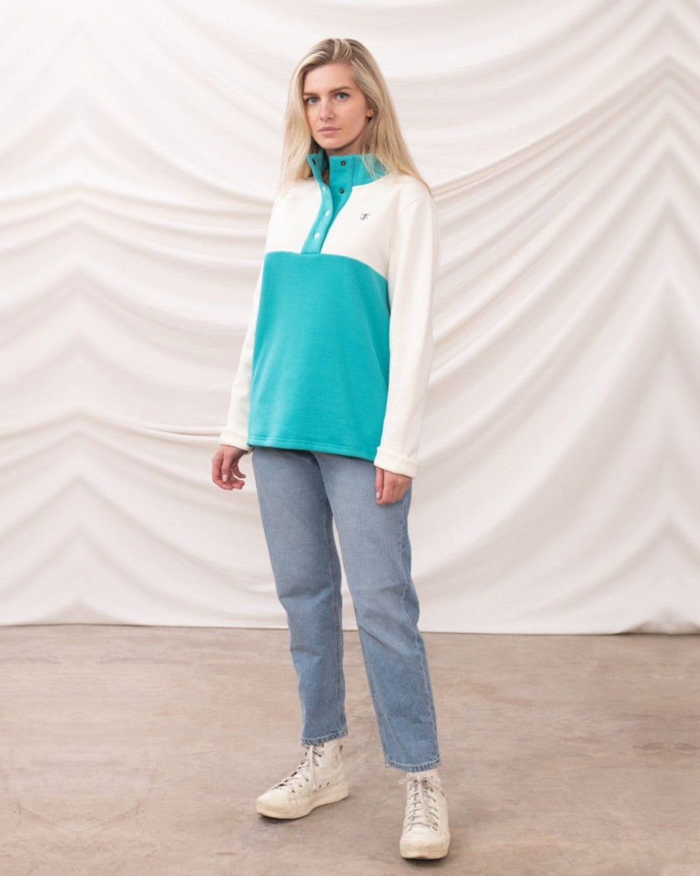 Coconut Soft Teal coloured Lighthouse Ladies Haven Jersey on curtain background