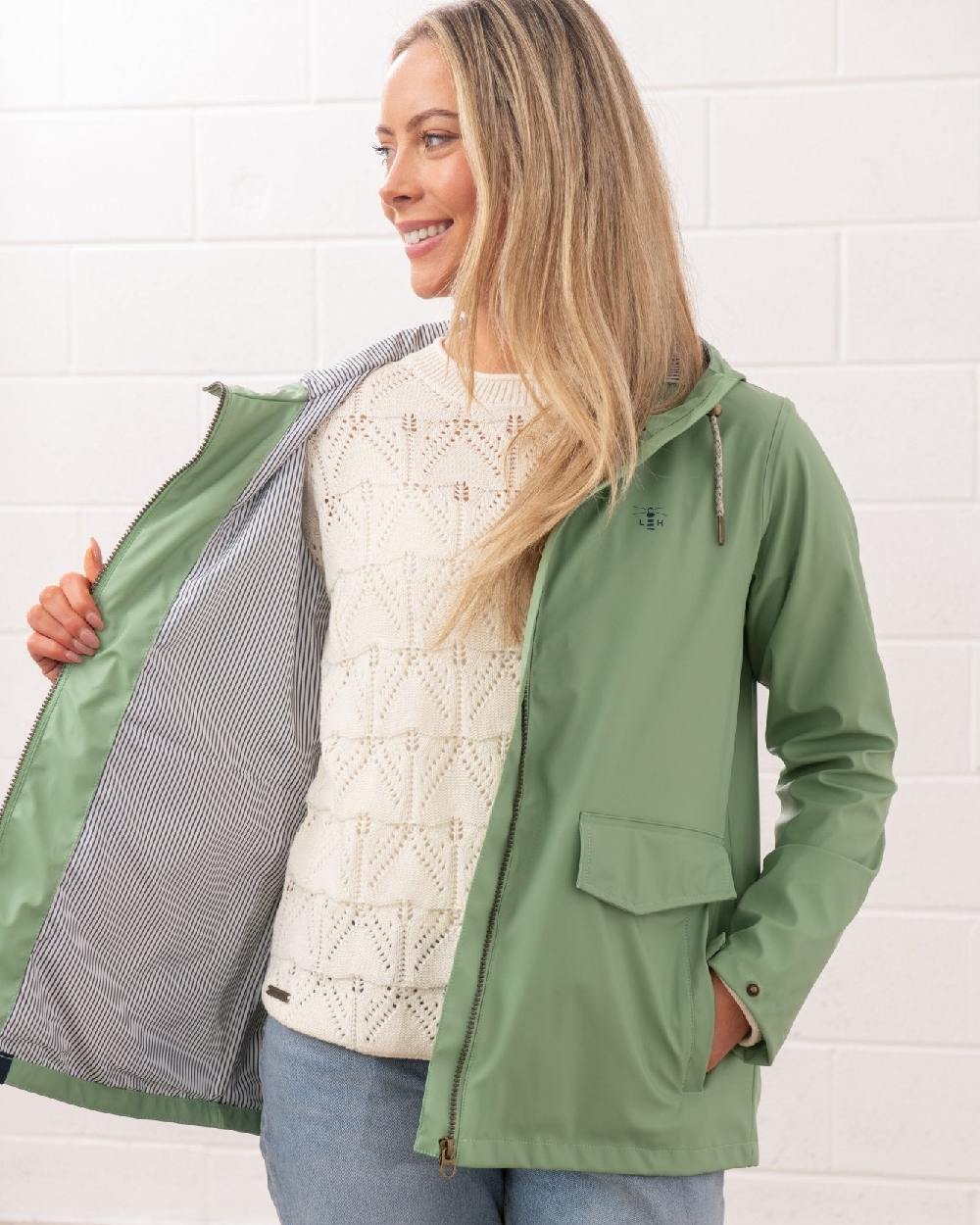 Soft Sage coloured Lighthouse Ladies Lucy Jacket on wall background