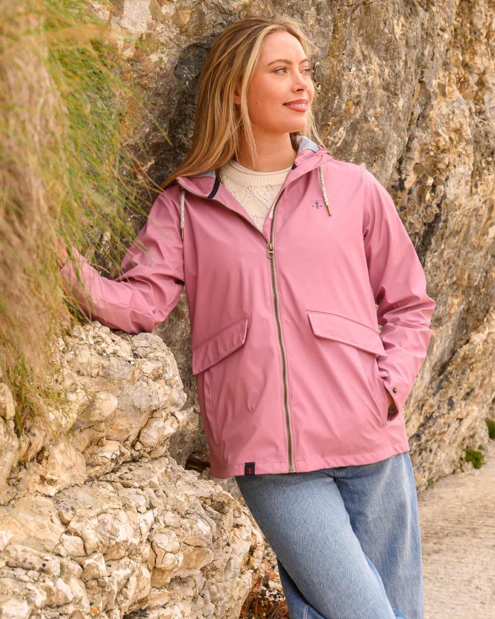 Wild Rose coloured Lighthouse Ladies Lucy Jacket on rock background