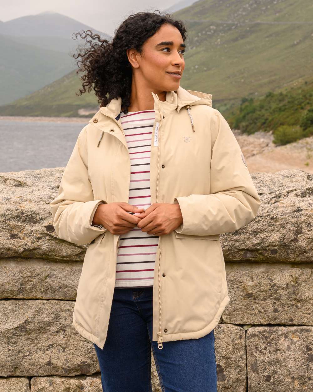 Cream coloured Lighthouse Ladies Tess Coat on sea background