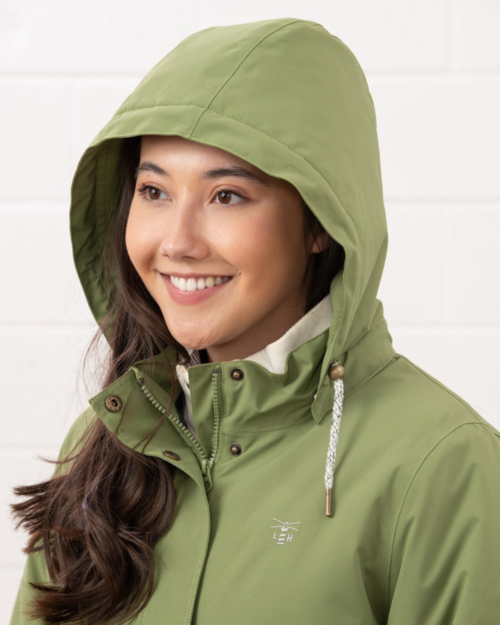 Sea Kelp coloured Lighthouse Ladies Tess Coat on wall background