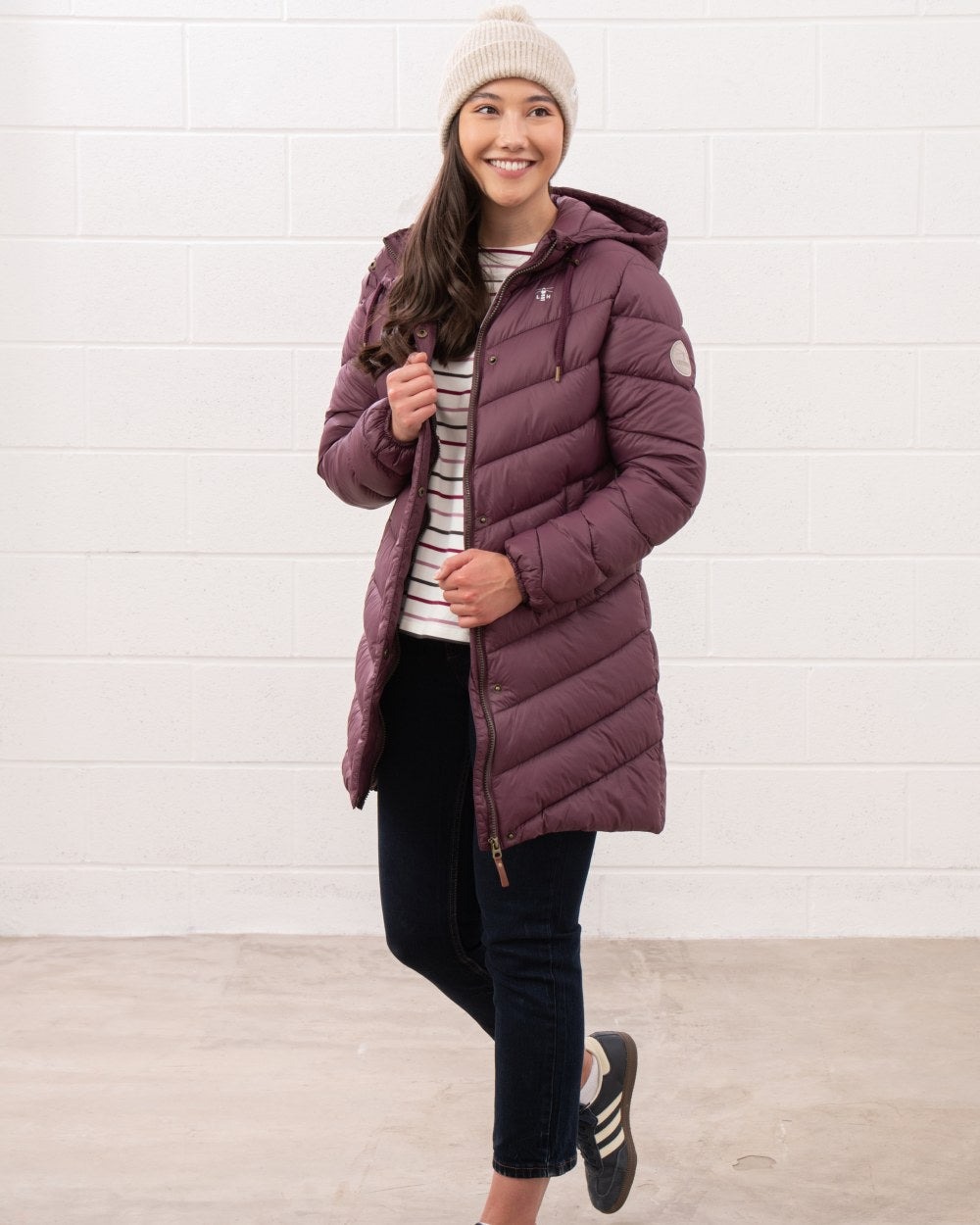 Cranberry coloured Lighthouse Laurel Ladies Coat on wall background