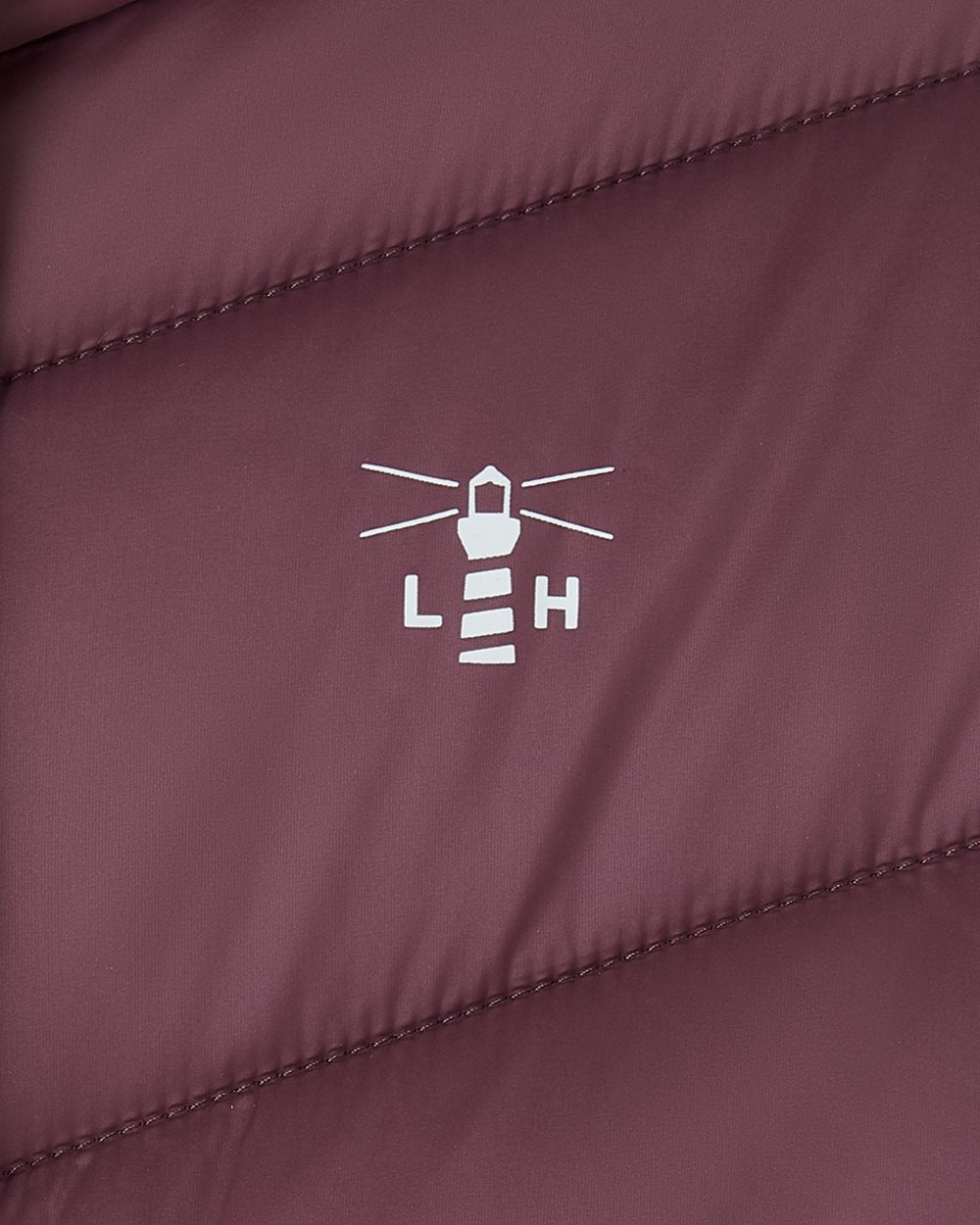 Cranberry coloured Lighthouse Laurel Ladies Coat on wall background