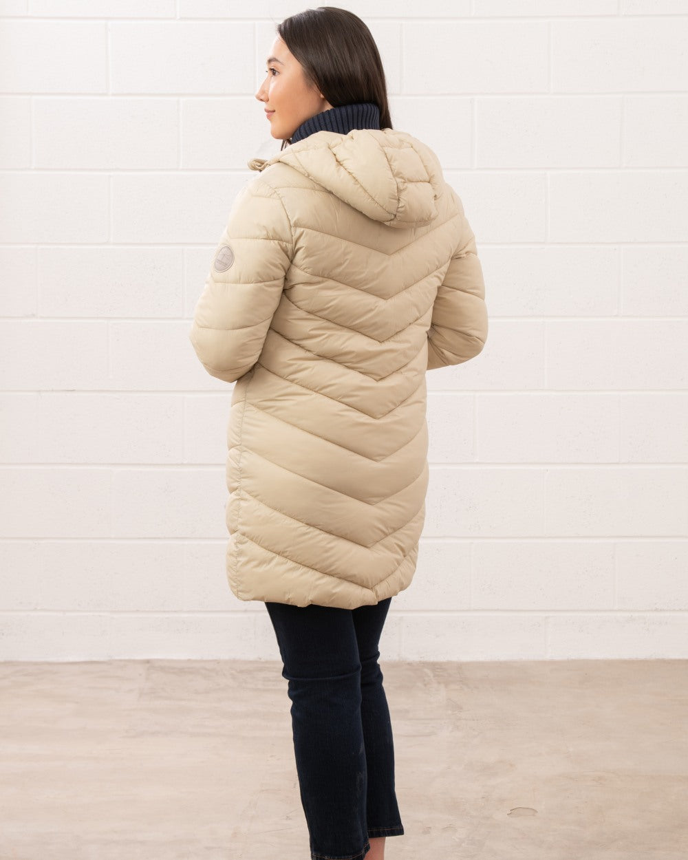 Cream coloured Lighthouse Laurel Ladies Coat on wall background