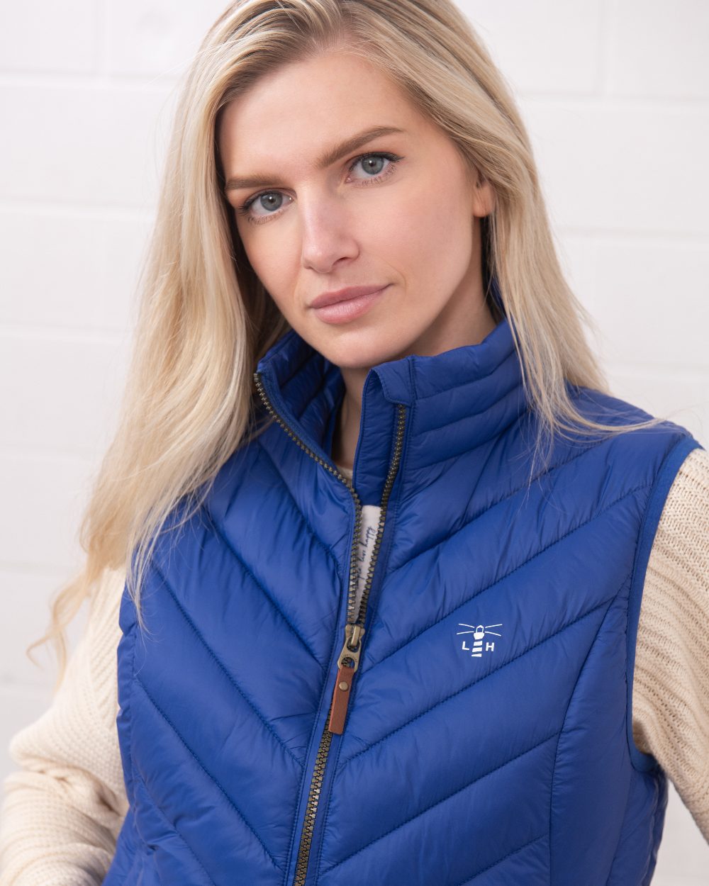 Indigo coloured Lighthouse Laurel Ladies Gilet on wall background