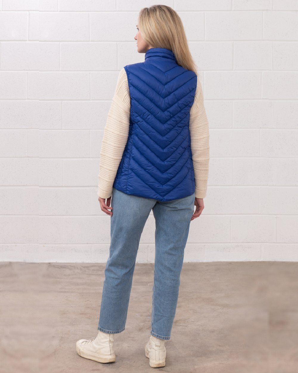Indigo coloured Lighthouse Laurel Ladies Gilet on wall background