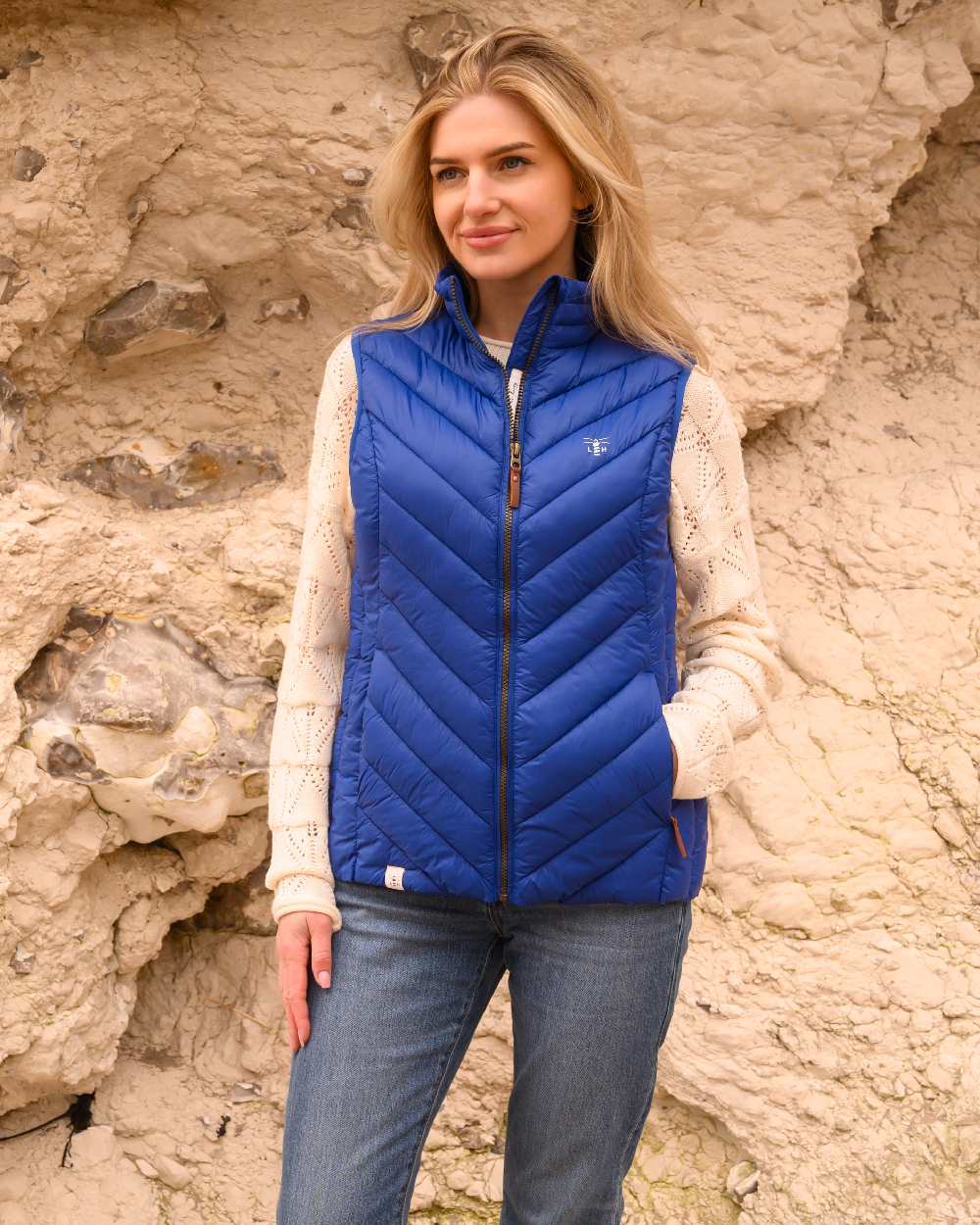 Indigo coloured Lighthouse Laurel Ladies Gilet on rock background