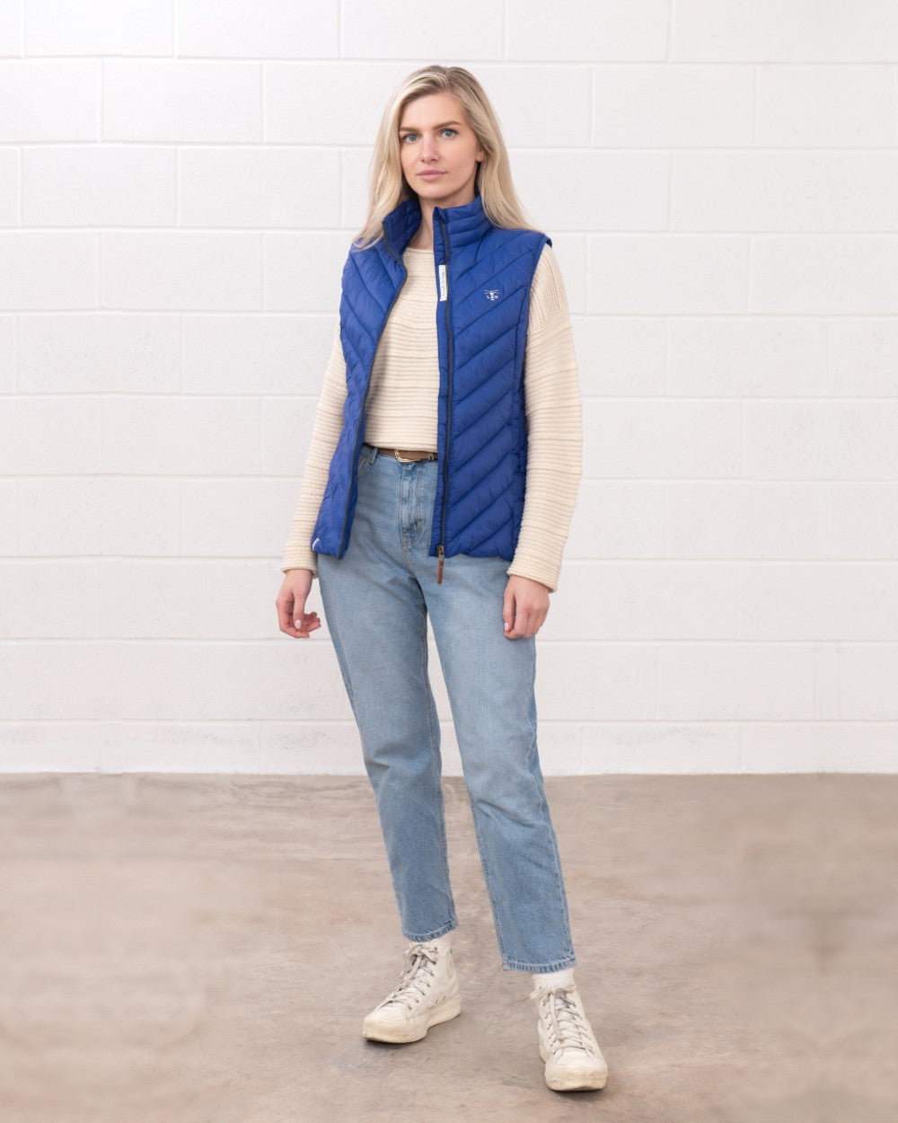 Indigo coloured Lighthouse Laurel Ladies Gilet on wall background