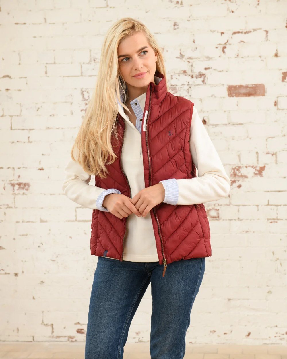 Maroon coloured Lighthouse Laurel Ladies Gilet on wall background