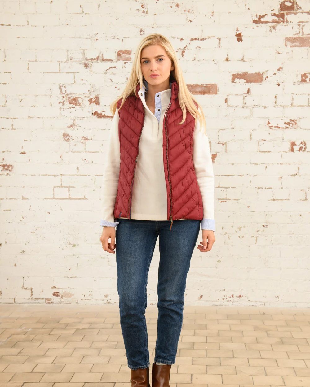 Maroon coloured Lighthouse Laurel Ladies Gilet on wall background