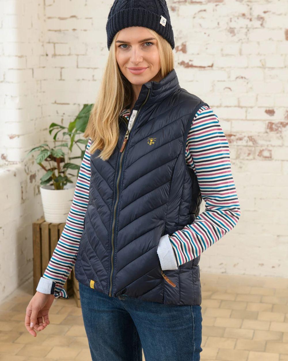 Navy coloured Lighthouse Laurel Ladies Gilet on wall background