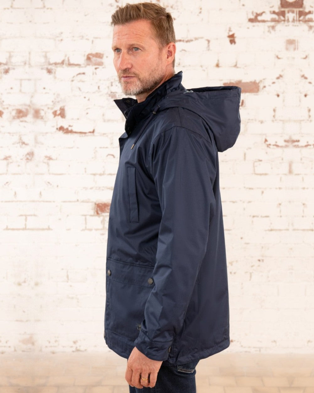 Navy coloured Lighthouse Mens Oxford Raincoat on wall background
