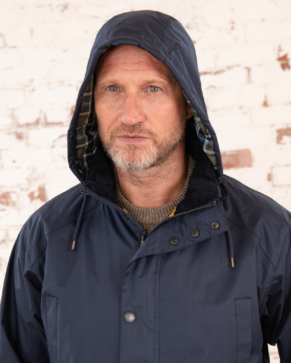 Navy coloured Lighthouse Mens Oxford Raincoat on wall background