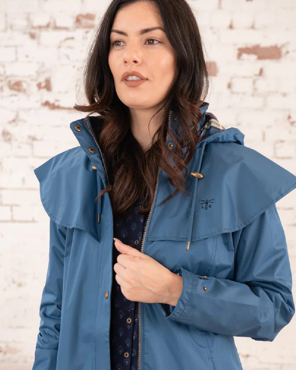 Deep Sea coloured Lighthouse Outback Full Length Ladies Waterproof Raincoat on wall background