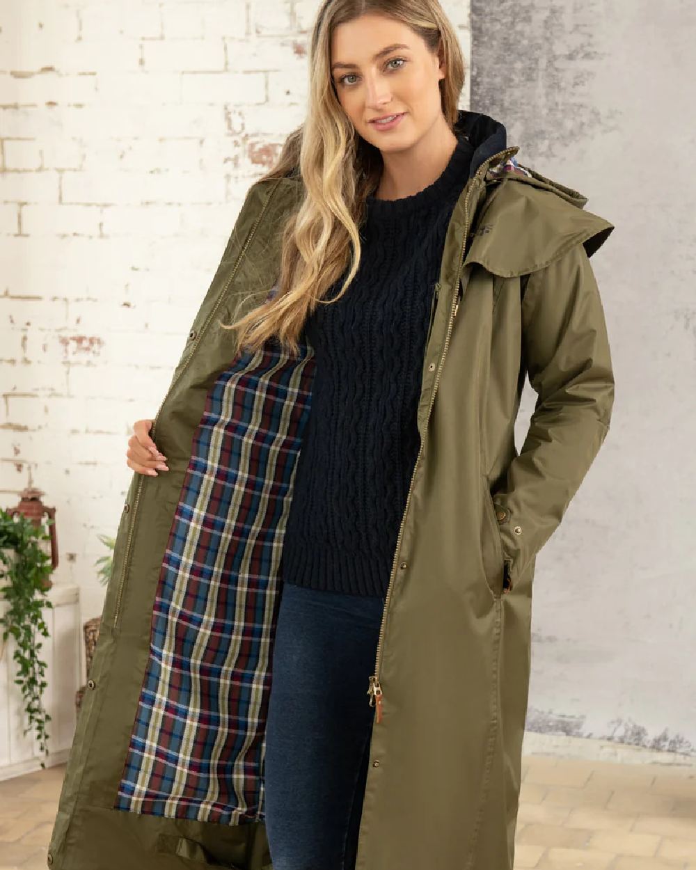 Fern coloured Lighthouse Outback Full Length Ladies Waterproof Raincoat on wall background