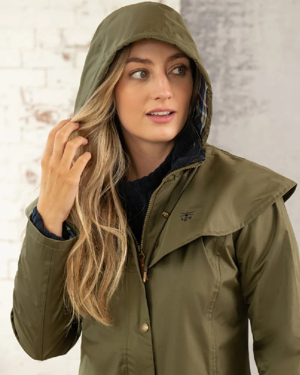 Fern coloured Lighthouse Outback Full Length Ladies Waterproof Raincoat on wall background