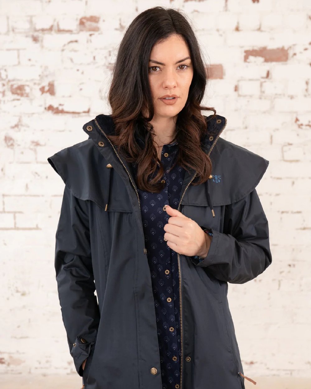 Nightshade coloured Lighthouse Outback Full Length Ladies Waterproof Raincoat on wall background
