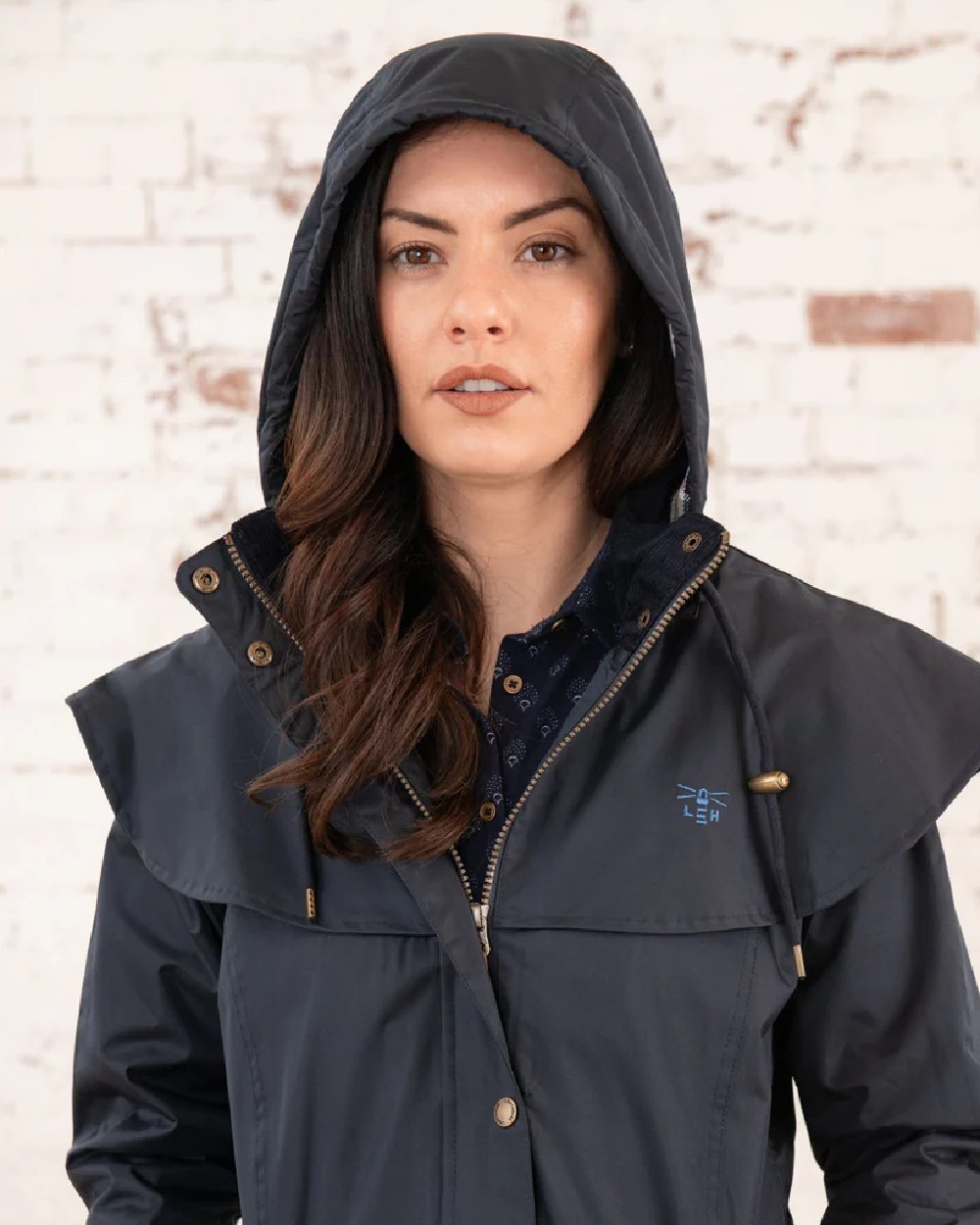 Nightshade coloured Lighthouse Outback Full Length Ladies Waterproof Raincoat on wall background