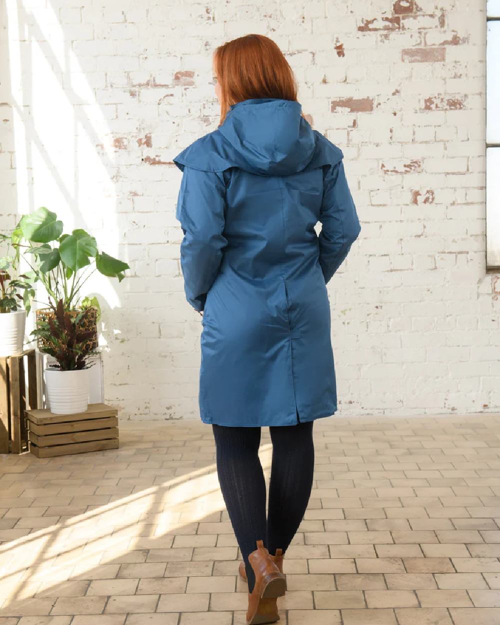 Deep Sea coloured Lighthouse Outrider 3/4 Length Ladies Waterproof Raincoat on wall background