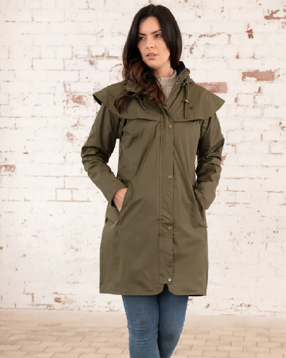 Fern coloured Lighthouse Outrider 3/4 Length Ladies Waterproof Raincoat on wall background