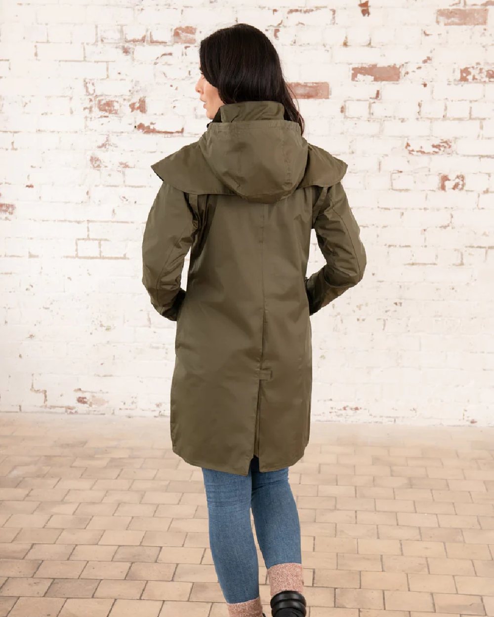 Fern coloured Lighthouse Outrider 3/4 Length Ladies Waterproof Raincoat on wall background