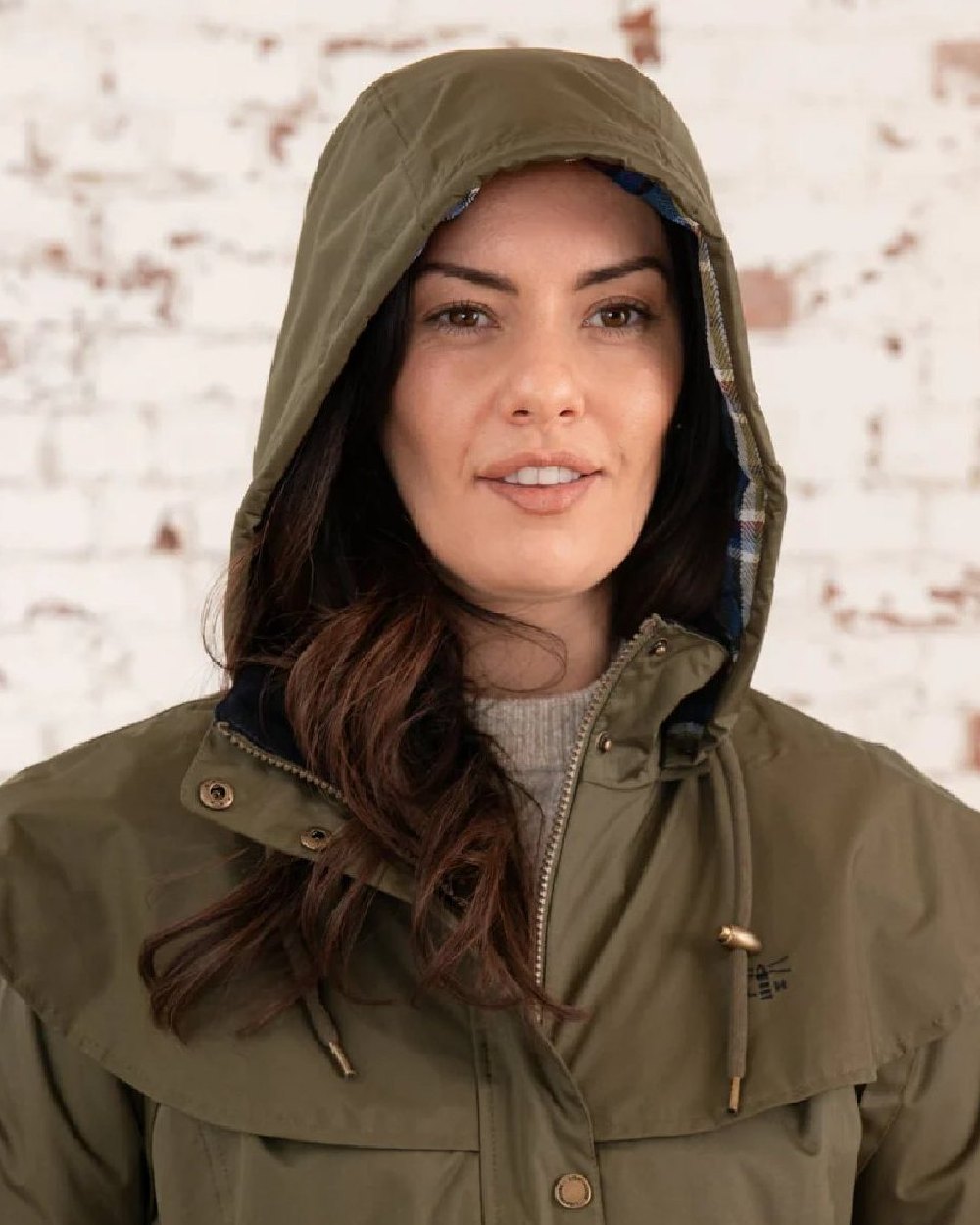 Fern coloured Lighthouse Outrider 3/4 Length Ladies Waterproof Raincoat on wall background