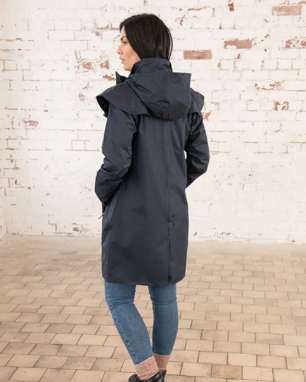 Nightshade coloured Lighthouse Outrider 3/4 Length Ladies Waterproof Raincoat on wall background