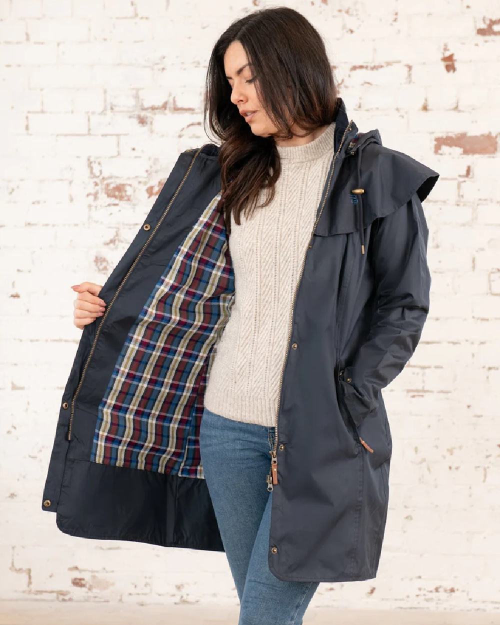 Nightshade coloured Lighthouse Outrider 3/4 Length Ladies Waterproof Raincoat on wall background