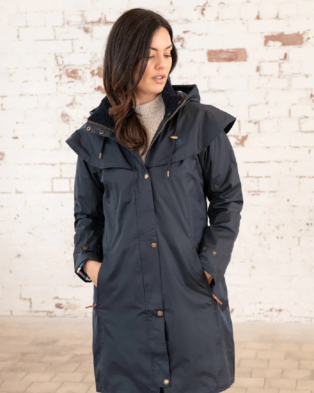 Nightshade coloured Lighthouse Outrider 3/4 Length Ladies Waterproof Raincoat on wall background