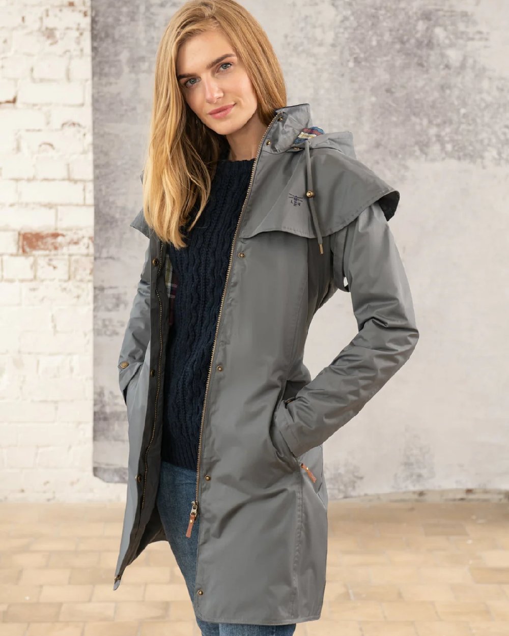 Urban Grey coloured Lighthouse Outrider 3/4 Length Ladies Waterproof Raincoat on wall background