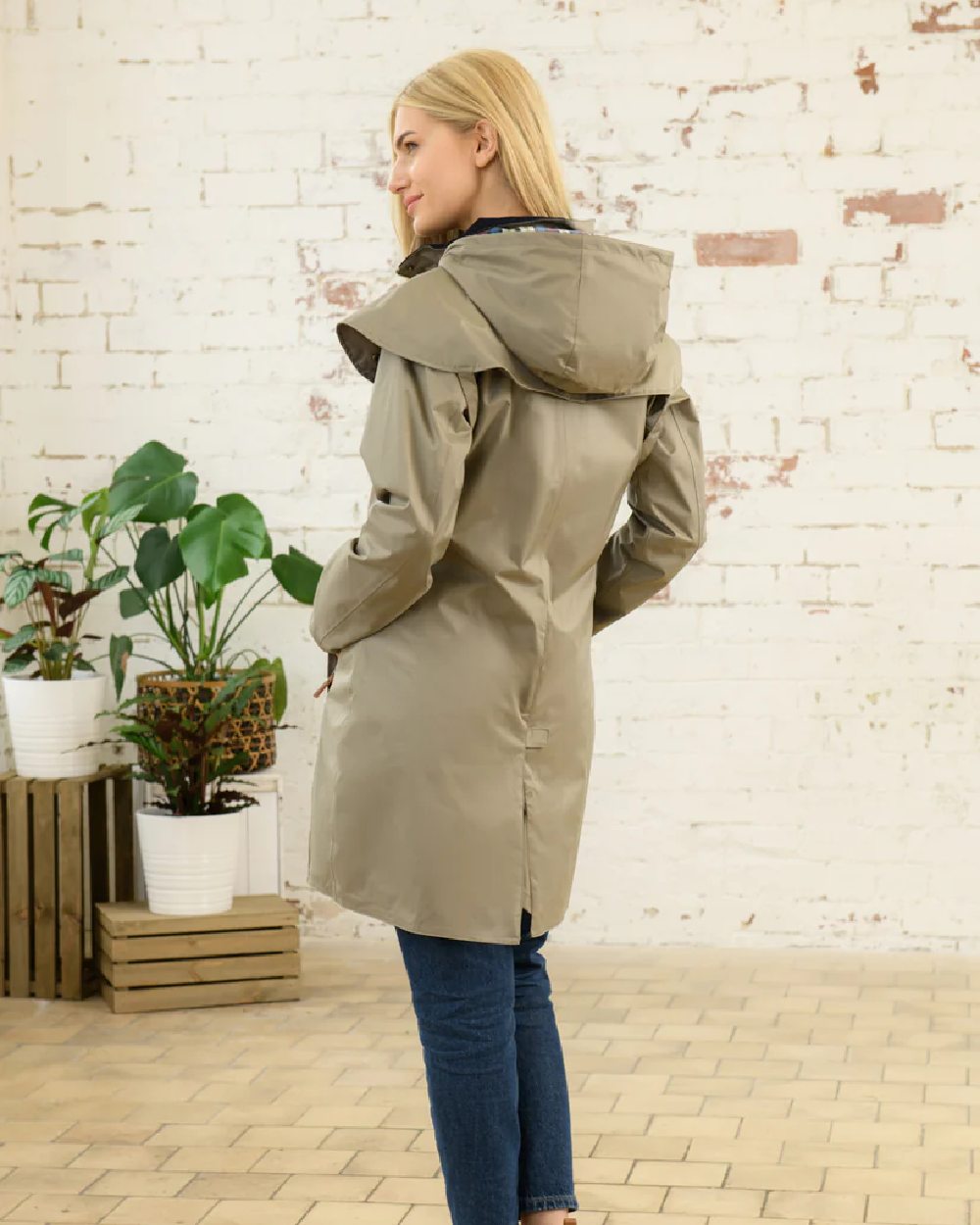 Fawn coloured Lighthouse Outrider 3/4 Length Ladies Waterproof Raincoat on wall background