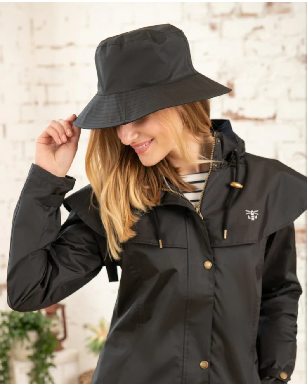 Black coloured Lighthouse Storm Waterproof Hat on wall background