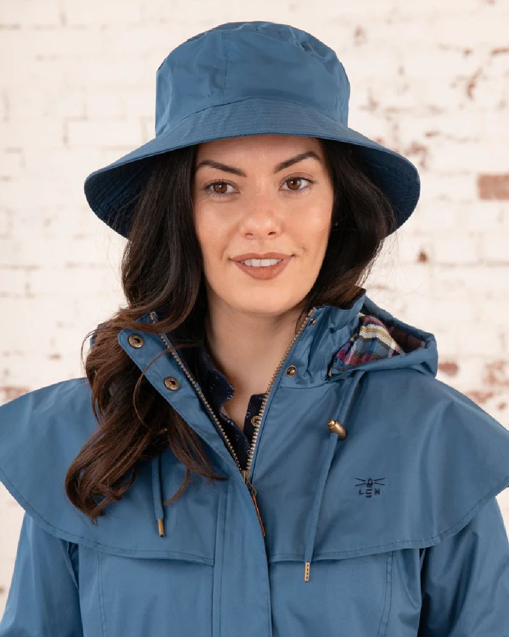 Deep Sea coloured Lighthouse Storm Waterproof Hat on wall background