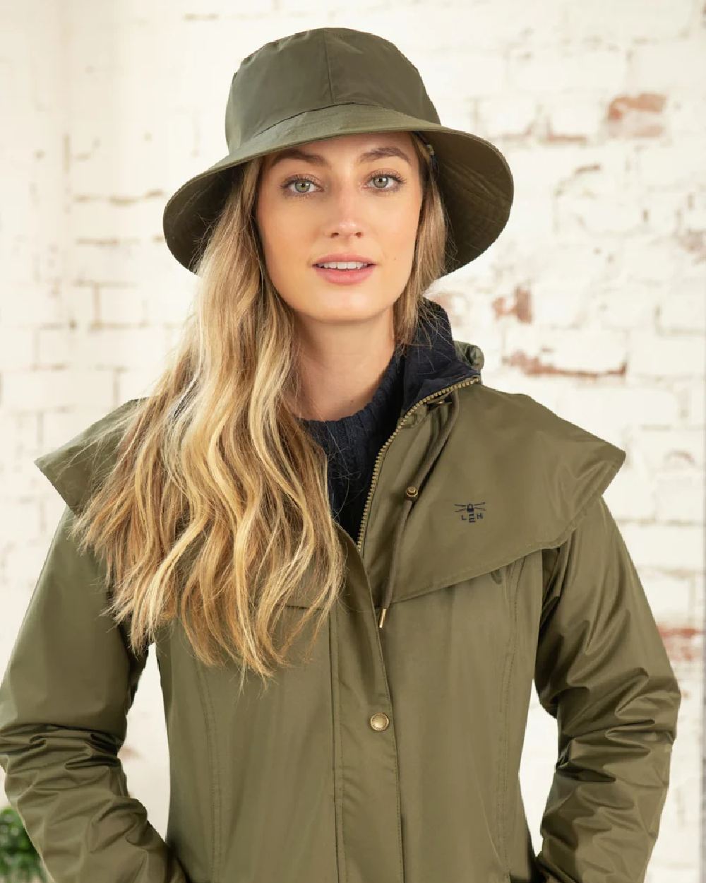 Fern coloured Lighthouse Storm Waterproof Hat on wall background