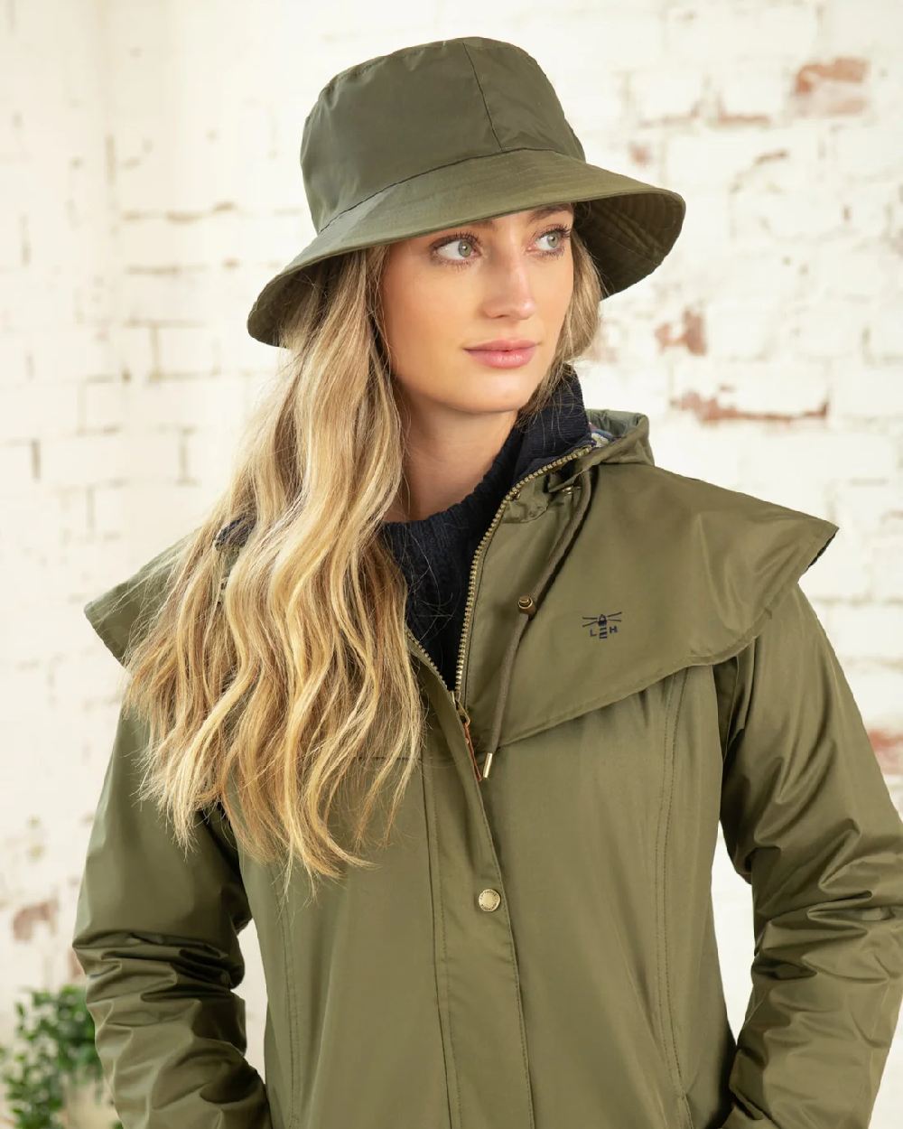Fern coloured Lighthouse Storm Waterproof Hat on wall background